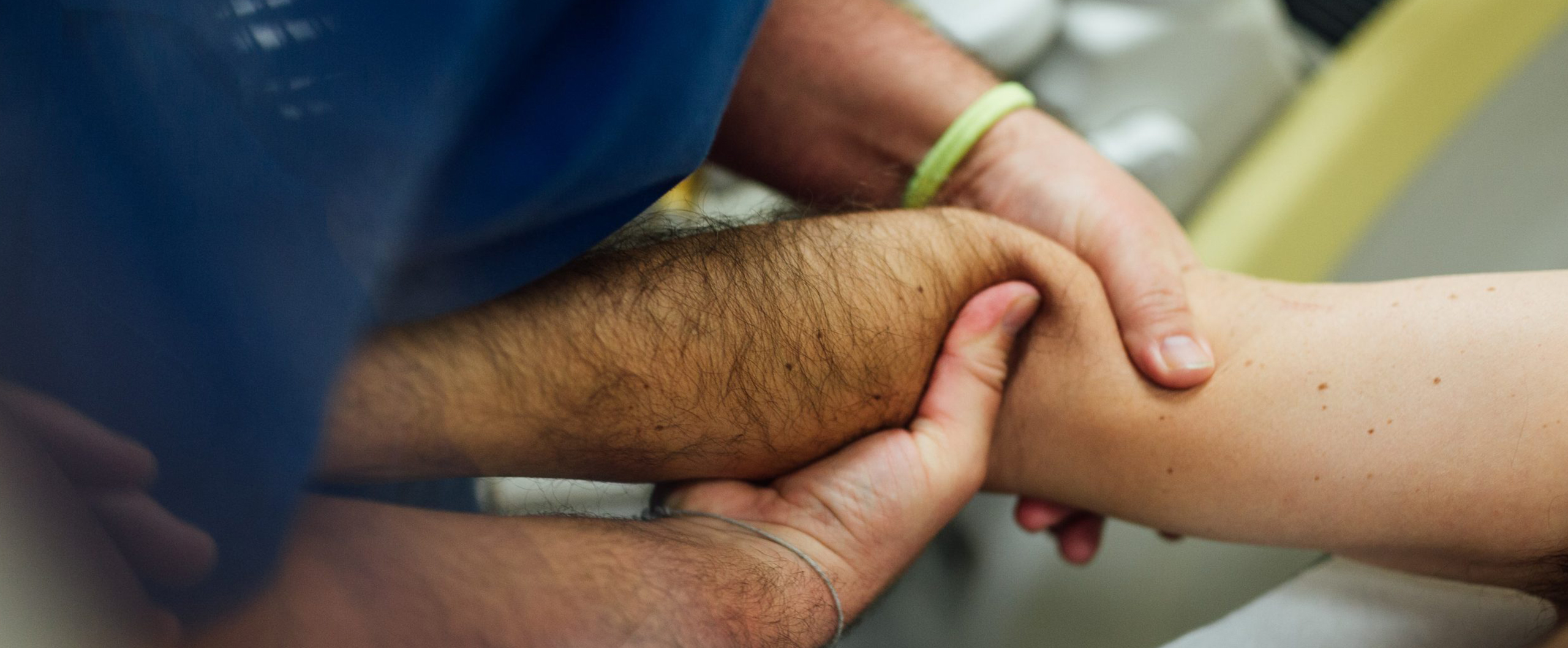 Un fisioterapueta de Mdiesport realiza una exploración cpon las manos en el brazo de un atleta lesionado